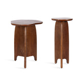 Two-piece table set with irregularly shaped tops and tripod bases made of warm-toned smooth wood, featuring gently curved legs and a natural finish.