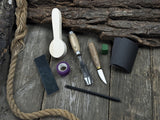 The Perfect Spoon Carving Kit for Beginners with tools, wooden blank, sandpaper, and sharpening board