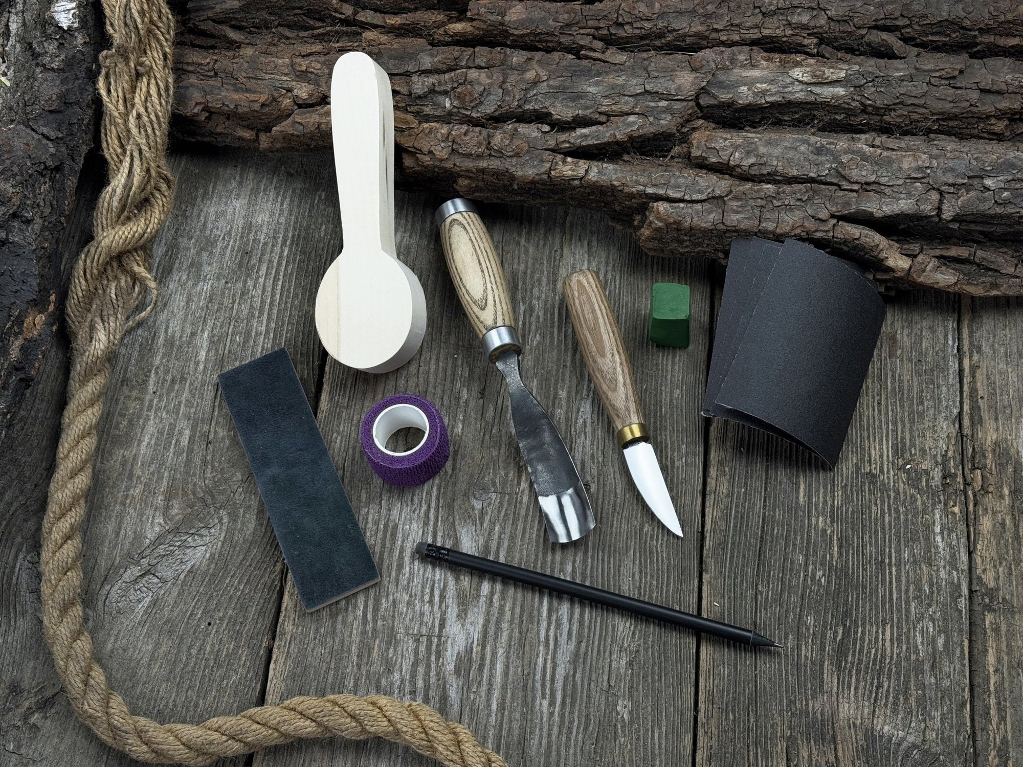 The Perfect Spoon Carving Kit for Beginners with tools, wooden blank, sandpaper, and sharpening board