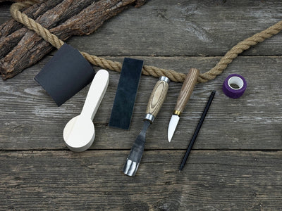 The Perfect Spoon Carving Kit for Beginners with tools, wooden blank, sandpaper, and sharpening board