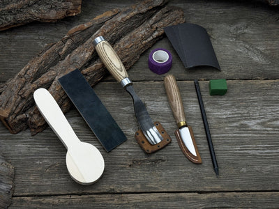 The Perfect Spoon Carving Kit for Beginners with tools, wooden blank, sandpaper, and sharpening board