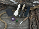 The Ultimate Beginner’s Spoon Carving Kit with tools, wooden blank, sandpaper, and sharpening board