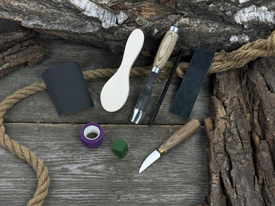 The Ultimate Beginner’s Spoon Carving Kit with tools, wooden blank, sandpaper, and sharpening board