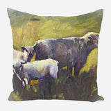 Painting-style pillow showing one adult sheep and two lambs with textured brushstrokes in muted greens, yellows, grays, and purples.