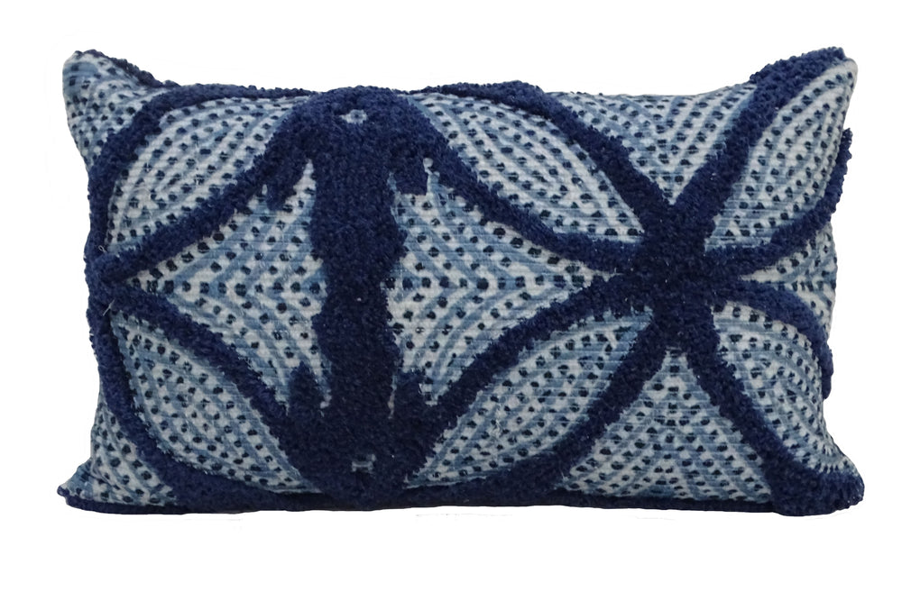 Blue throw pillow with tufted cotton pattern placed on a couch