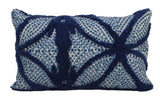 Blue throw pillow with tufted cotton pattern placed on a couch