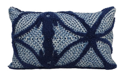 Blue throw pillow with tufted cotton pattern placed on a couch
