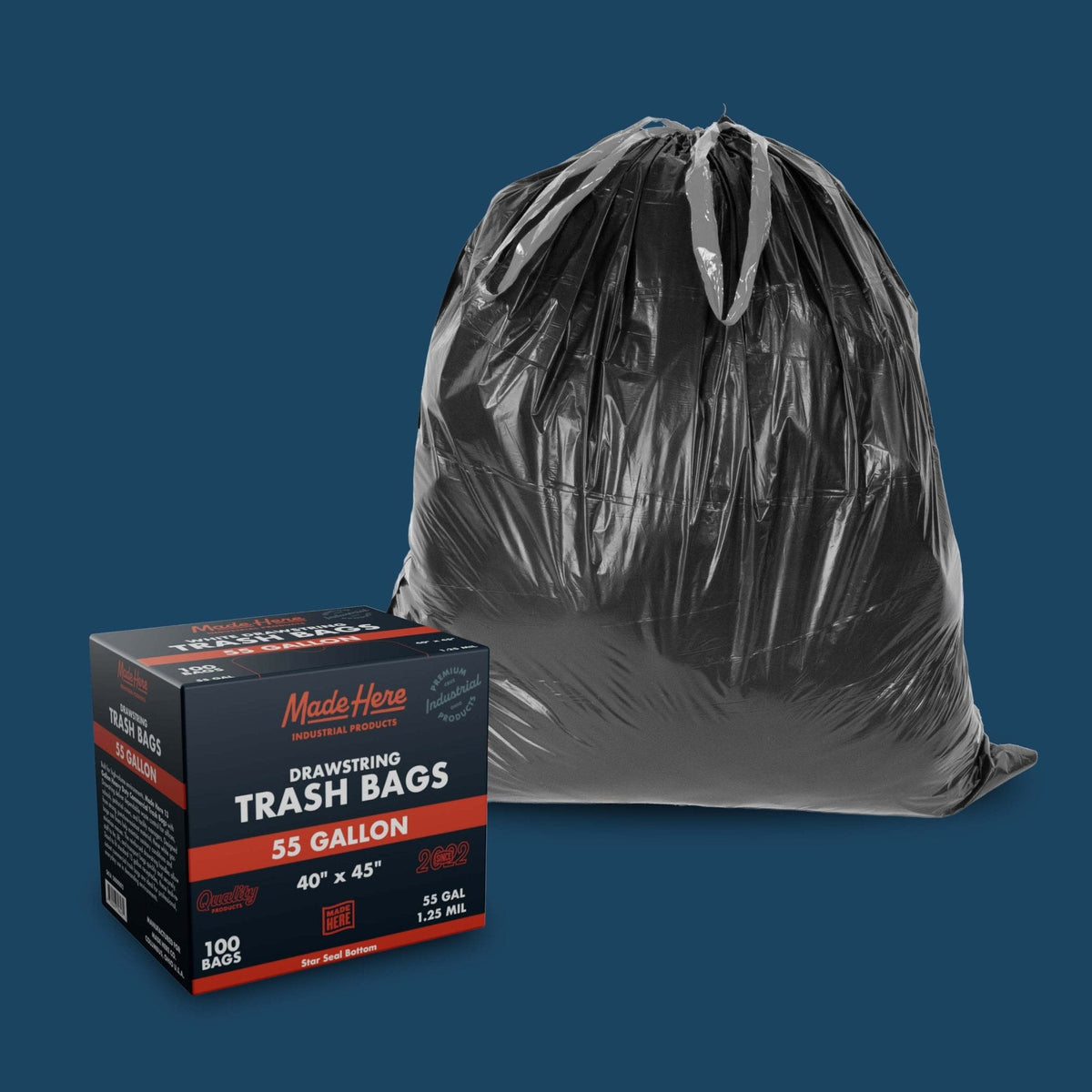 Black 55-gallon drawstring trash bag filled and tied, next to its rectangular packaging box displaying product details on a blue background.