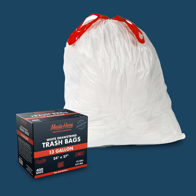 White commercial trash bags with reinforced drawstring handles displayed in a stack
