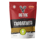 Red, black, and white bag of BIG TINE TRIGGERED protein and mineral attractant with pear flavor, featuring a deer head logo and green pear icon on front