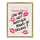 Pink guest check form with black handwritten text saying 'Can we get another round of drinks?' and surrounded by five pink lipstick kiss marks on a white background.