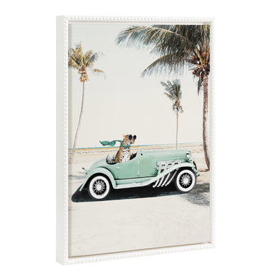 Framed canvas artwork depicting a leopard in a car surrounded by beach palms with a vintage beaded gold frame
