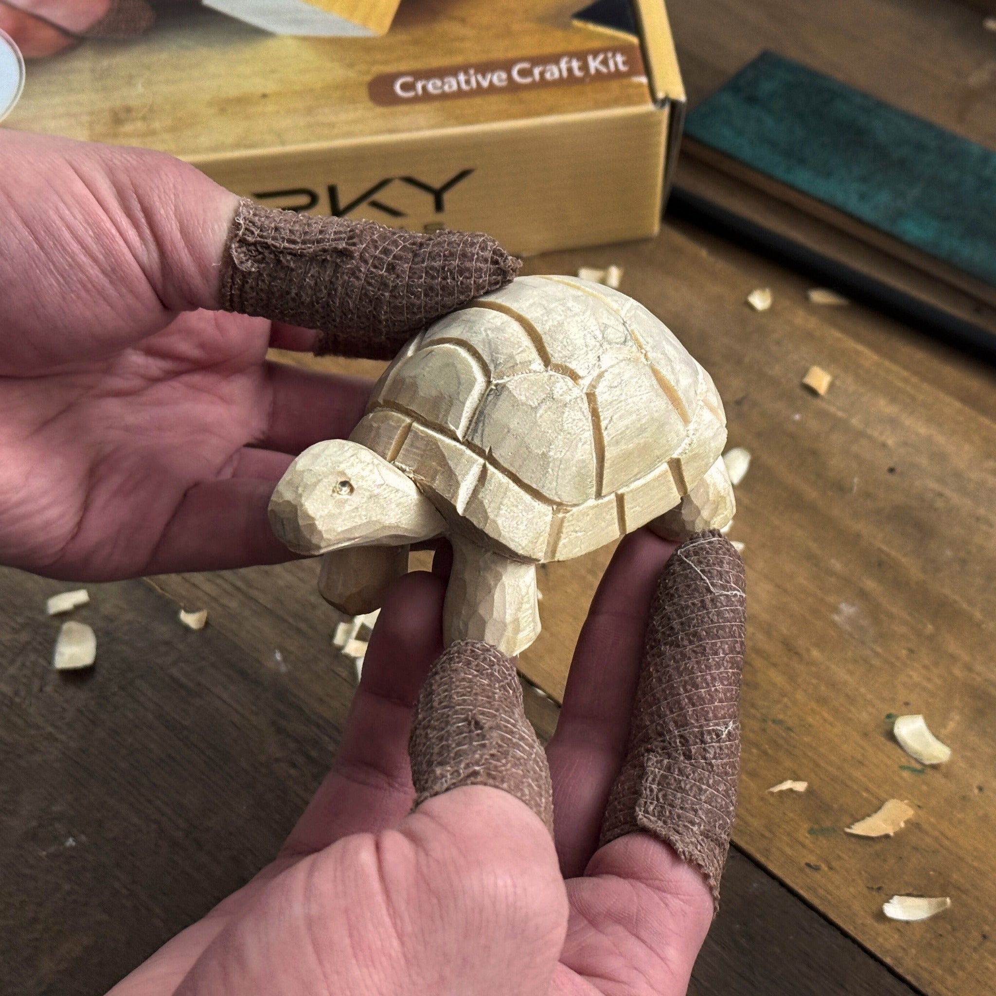 Turtle Carving Kit with knife, wooden blocks, sandpaper, sharpening board, pencil, and turtle drawing