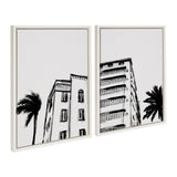 Two black and white framed art prints depicting Miami Beach Art Deco buildings with palm trees against a plain white background, emphasizing architectural details.
