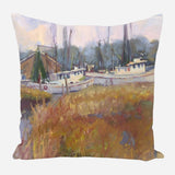 Pillow featuring an impressionistic painting of white boats docked by a wooden pier with tall grasses in autumn tones in the foreground and misty blue-gray trees in the background.