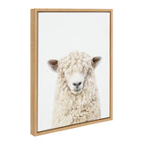 Framed canvas portrait of a cream-colored sheep with curly wool and bangs, set against a plain white background in a light wood frame.