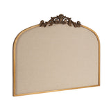 Arched pinboard with beige fabric surface and a gold frame topped by intricate bronze ornamental scrollwork flourish.