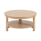 Round wood coffee table with a light natural finish, featuring a simple design with a lower circular shelf and four straight legs