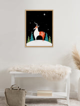 Simplified reindeer with white body and red saddle standing on snow with stylized green trees and a starry night sky in a wooden frame above a white bench with fur throw.