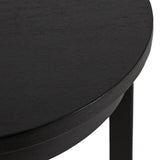 Close-up of a round black wooden side table with smooth finish and straight black legs visible beneath the top surface.