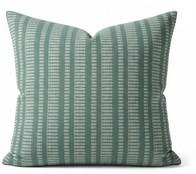 Green Oyo pillow cover featuring a woven cotton front next to other decorative pillows