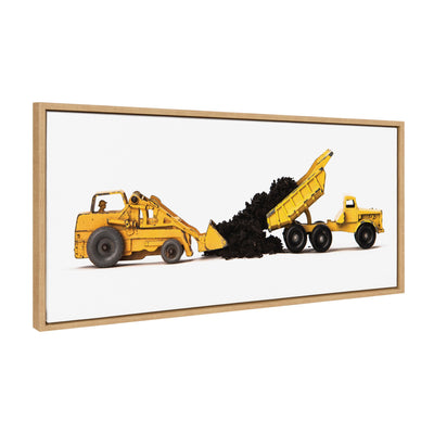 Framed canvas art showing stacked vintage toy construction vehicles on a yellow background