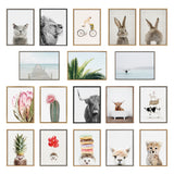A grid of fifteen framed prints featuring animals with neutral backgrounds, tropical plants, a pier scene, and whimsical food and balloon elements.