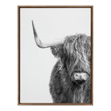 Black and white close-up of a Highland cow facing forward with long shaggy fur covering its eyes and prominent curved horn on the left side, framed in wood.