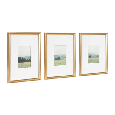 Three framed watercolor landscape artworks in vintage beveled frames arranged on a white wall