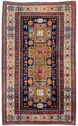 Vintage Armenian Karabakh rug with a deep blue center featuring four large star motifs in orange, green, and red, surrounded by intricate geometric borders in cream, red, and brown.