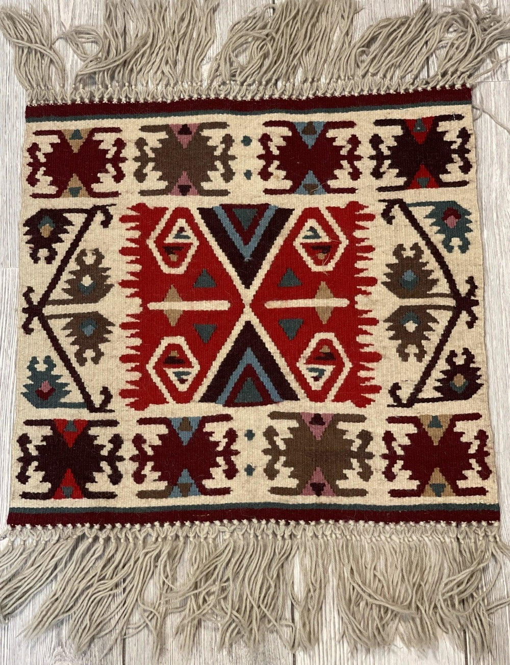Vintage Navajo Like Bulgarian Wool Kilim Display Rug laid on wooden floor