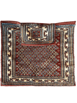 Rectangular vintage Baluch salt bag rug with intricate geometric patterns in deep red, cream, and blue tones framed by multiple patterned borders.