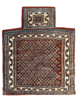 Rectangular vintage Baluch salt bag rug with a small attached pouch, featuring geometric patterns in deep red, cream, and dark blue tones.
