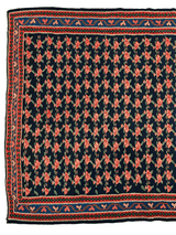 Vintage Persian Senneh Kilim rug with repeating red and green floral motifs on a dark navy background, bordered by geometric patterns in red, blue, and cream.