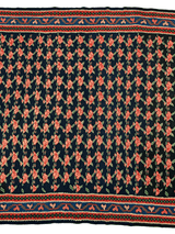 Vintage Persian Senneh Kilim rug with dense red and beige floral motifs on a black field, bordered by intricate geometric patterns in red, beige, and blue.