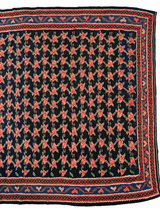 Vintage Persian Senneh Kilim rug with repeating red and pink floral motifs on a dark blue background, framed by intricate red, blue, and beige geometric borders.