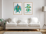Bright living room with white cushioned sofa beneath two framed abstract turtle-themed artworks in green and blue hues on a pale wall, next to a tall floor lamp and potted plant.