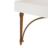Close-up of a white rectangular floating shelf supported by a brown metal triangular bracket with a curved support arm