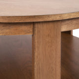 Close-up of a round wooden coffee table leg and part of the tabletop showing a smooth, light brown wood grain finish with straight, minimal design.