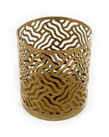 Cylindrical golden votive candle holder with an abstract wavy cutout pattern around its surface, shown against a white background.