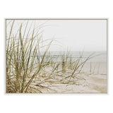Framed canvas print of beach grass growing on sandy dunes with a soft, muted seascape in the background under an overcast sky.
