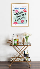 Framed canvas art of a guest check with blue lines, red lipstick marks, and handwritten text 'Another Martini Please!!' above a gold bar cart with liquor bottles, glasses, and white tulips.