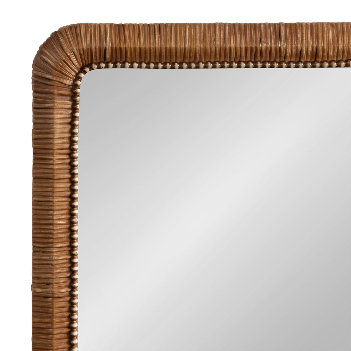 Close-up of a light brown wooden frame with rounded corners and a carved ribbed texture surrounding a smooth reflective mirror surface