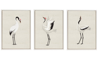 Three framed canvas art pieces depicting minimalist Japanese cranes with red crowns, arranged side by side on a neutral wall.