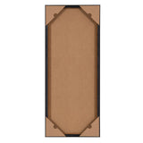 Rectangular black frame viewed from the back with brown protective corner covers and brown backing board secured within the frame.
