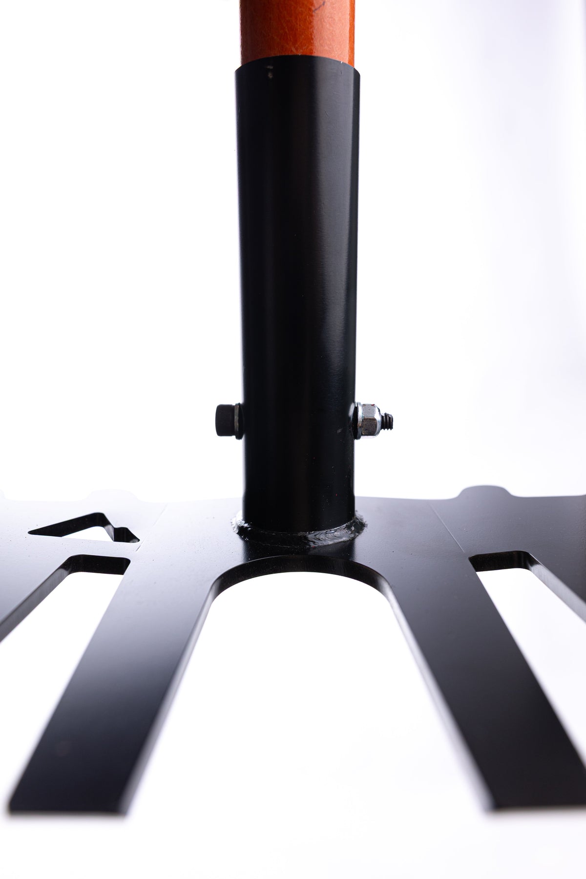 Black metal trident-shaped fork with a cylindrical orange handle attached by side bolts, shown against a white background from a low angle.