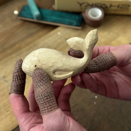 Whale Carving Kit with knife, wooden blocks, sandpaper, sharpening board, pencil, and whale drawing template