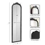 Tall, narrow rectangular mirror with an antique black finish frame, ornate crown detail on top, and D-ring hangers on the back for mounting.