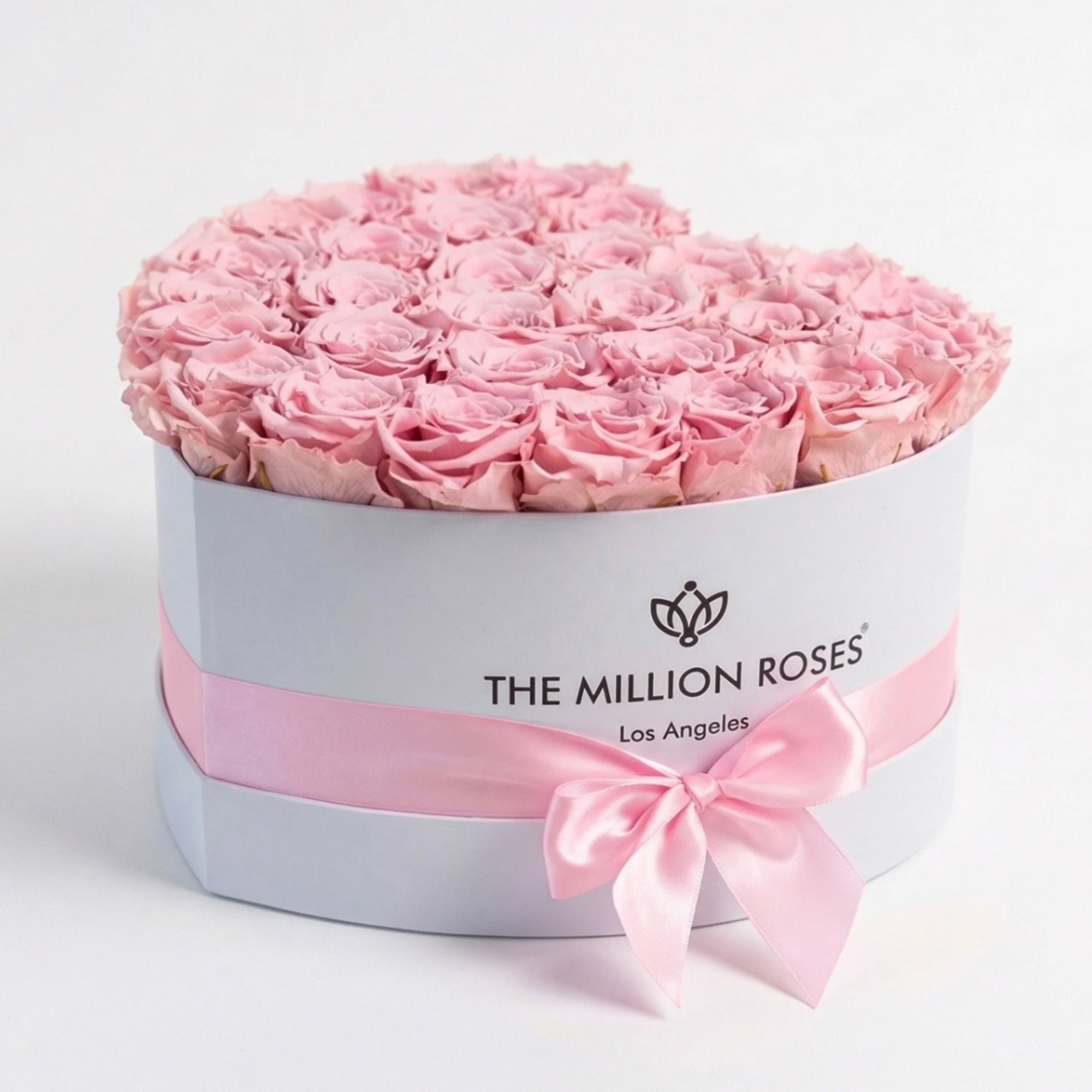 Heart-shaped white box filled with 28-30 light pink roses