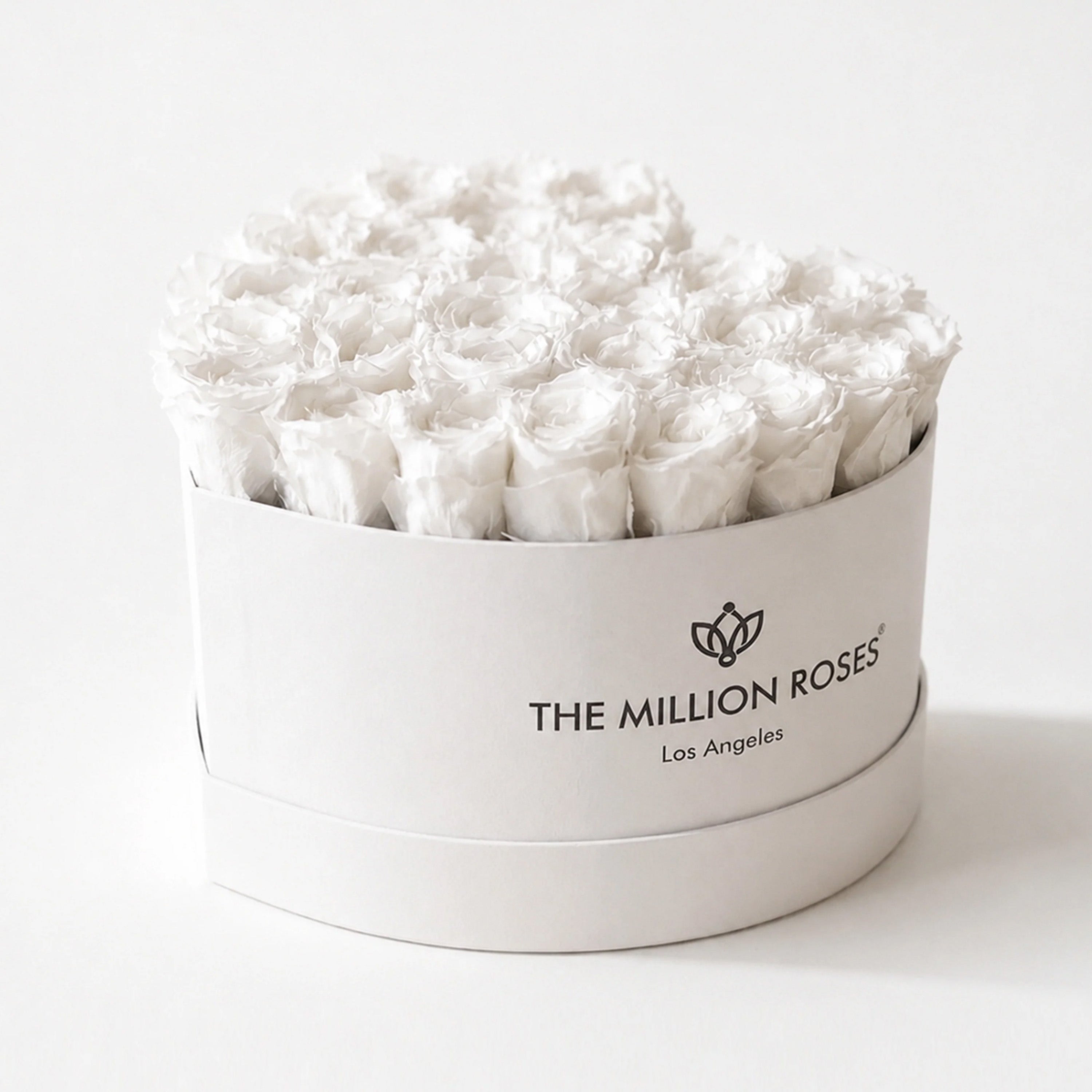 White heart-shaped box filled with 28-30 hand-formed white roses by The Million Roses